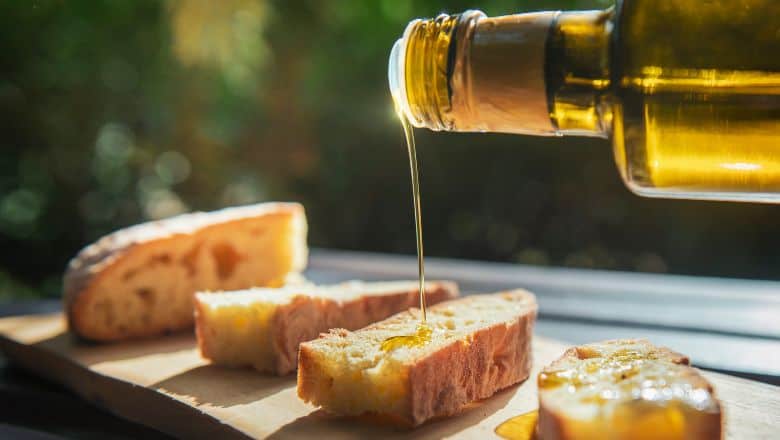 pouring olive oil to bread